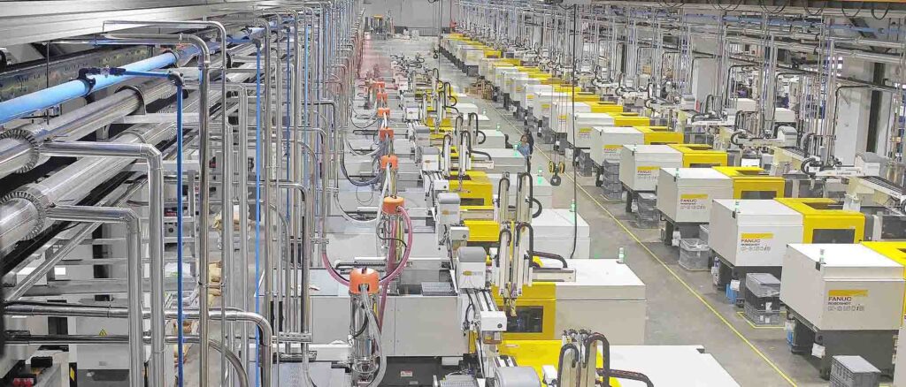 Injection molding workshop with multiple machines and automated feeding system
